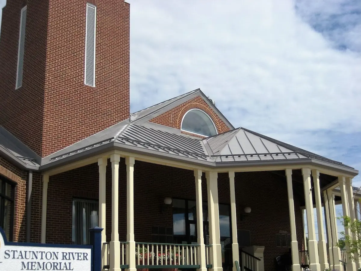 Skilled roofing craftsmen working on a residential roof in Piscataquog